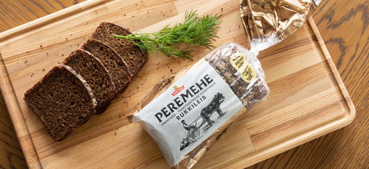 A top view of sliced rye bread with dill on a wooden tray, perfect for food photography.
