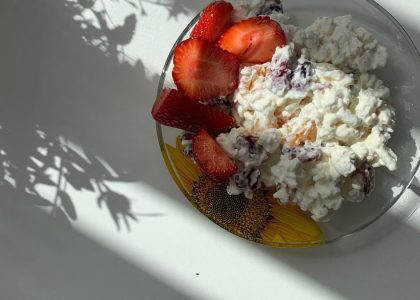 A sunlit plate of strawberries and cottage cheese perfect for breakfast.